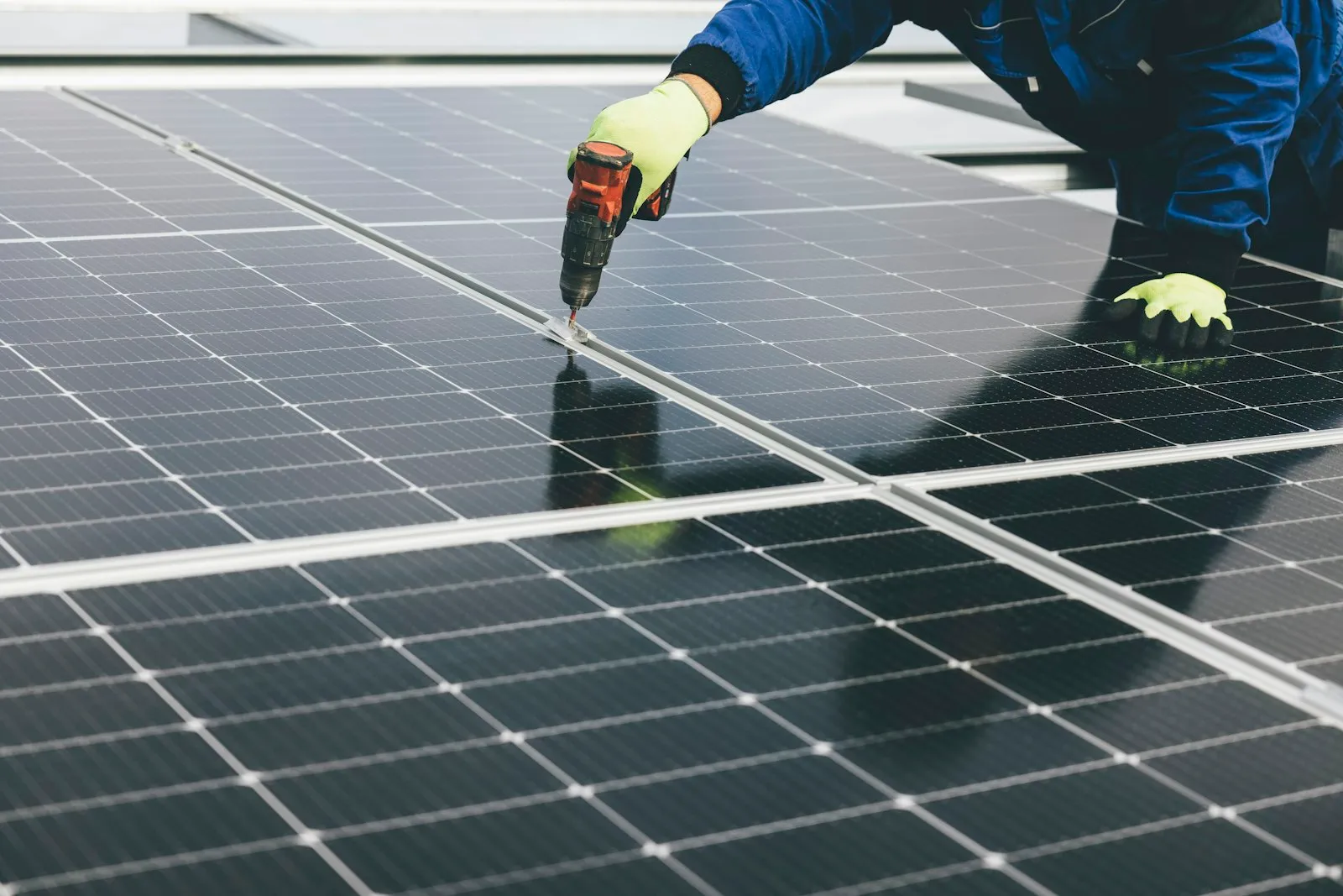 A technician inspecting solar panels on a production line